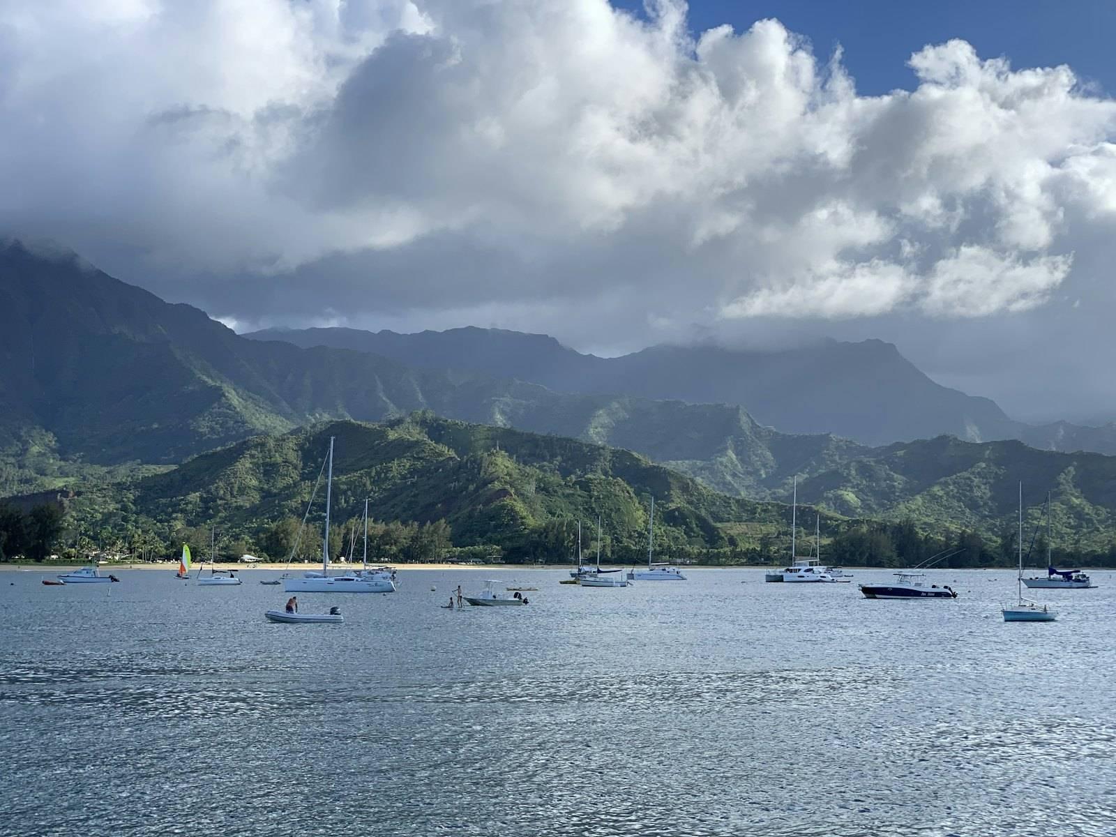 A group of boats floating on top of a body of water