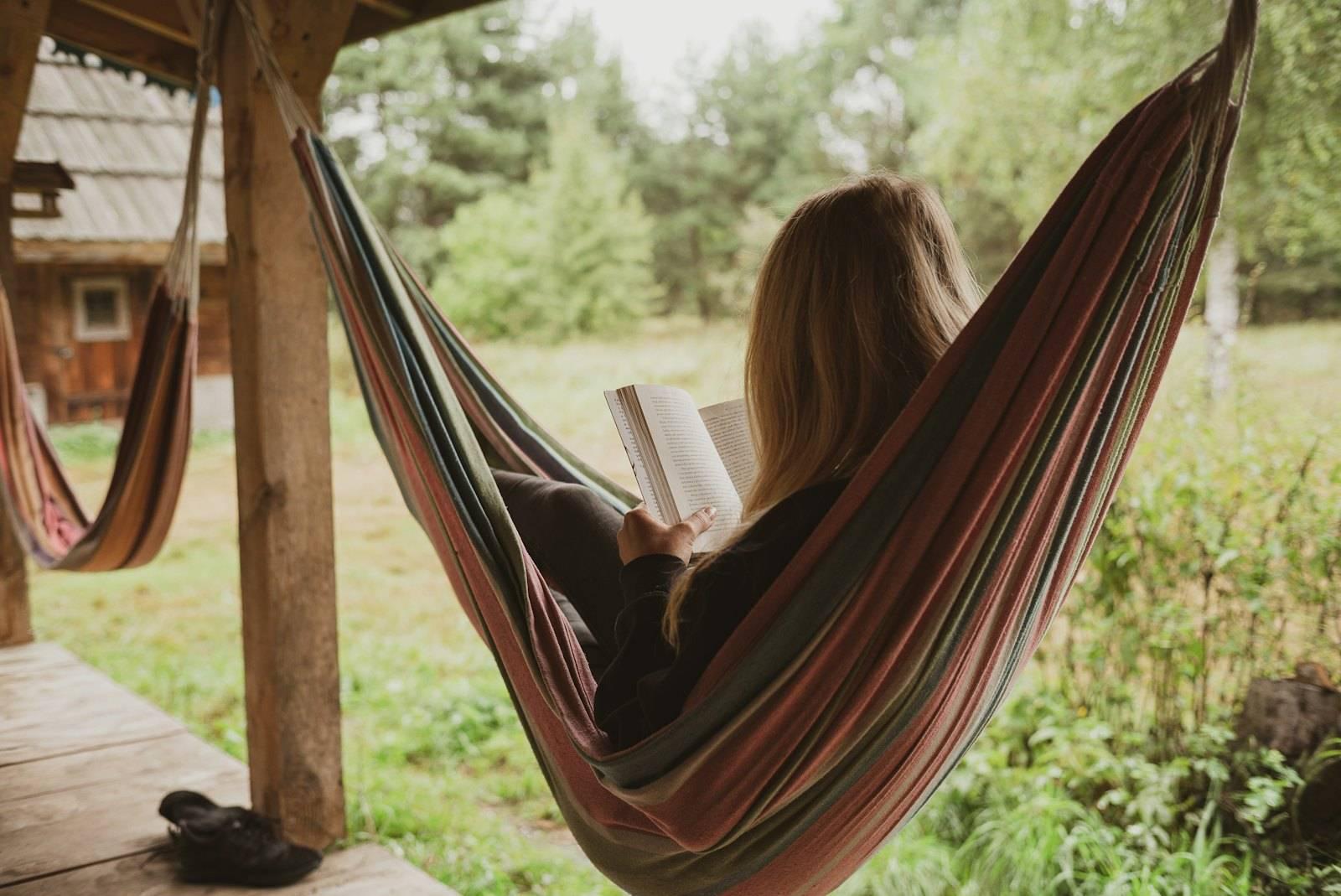 Woman reading book on hammock